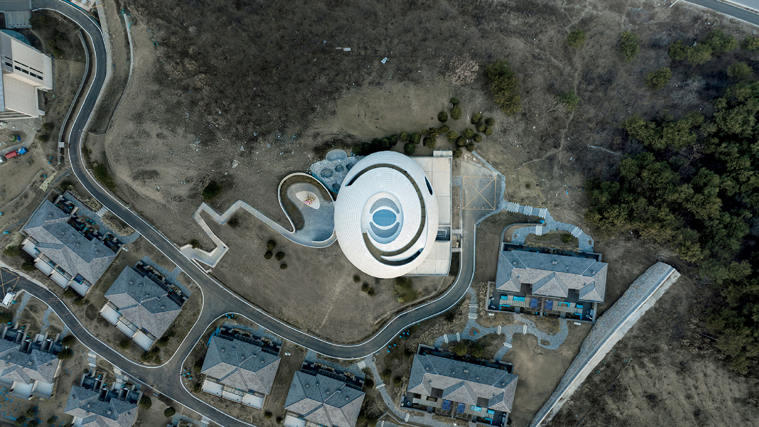 A circular building with a white roof