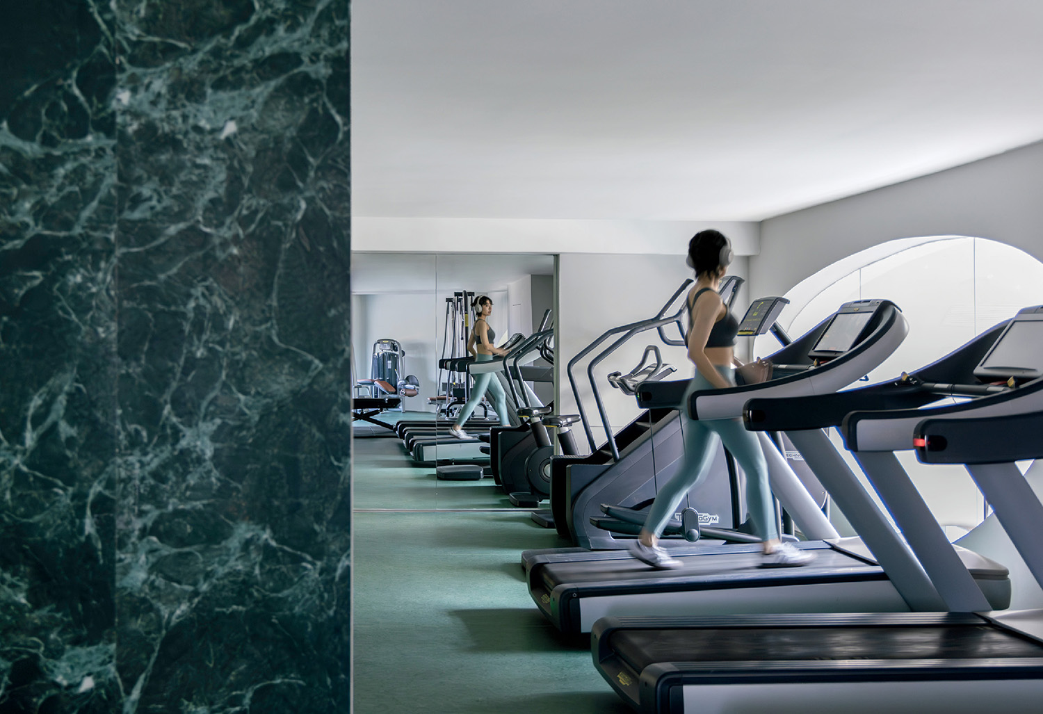 A woman is running on a treadmill