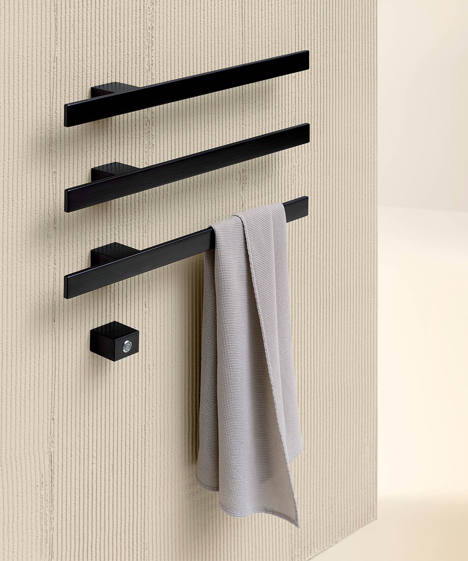 A towel rack with two towels hanging on it.