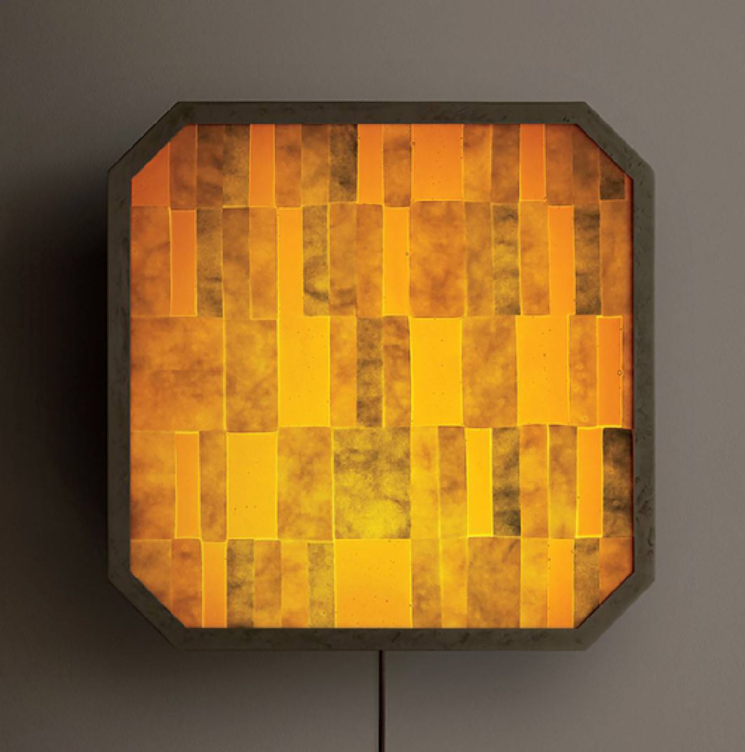 A yellow lamp with a square pattern on it.