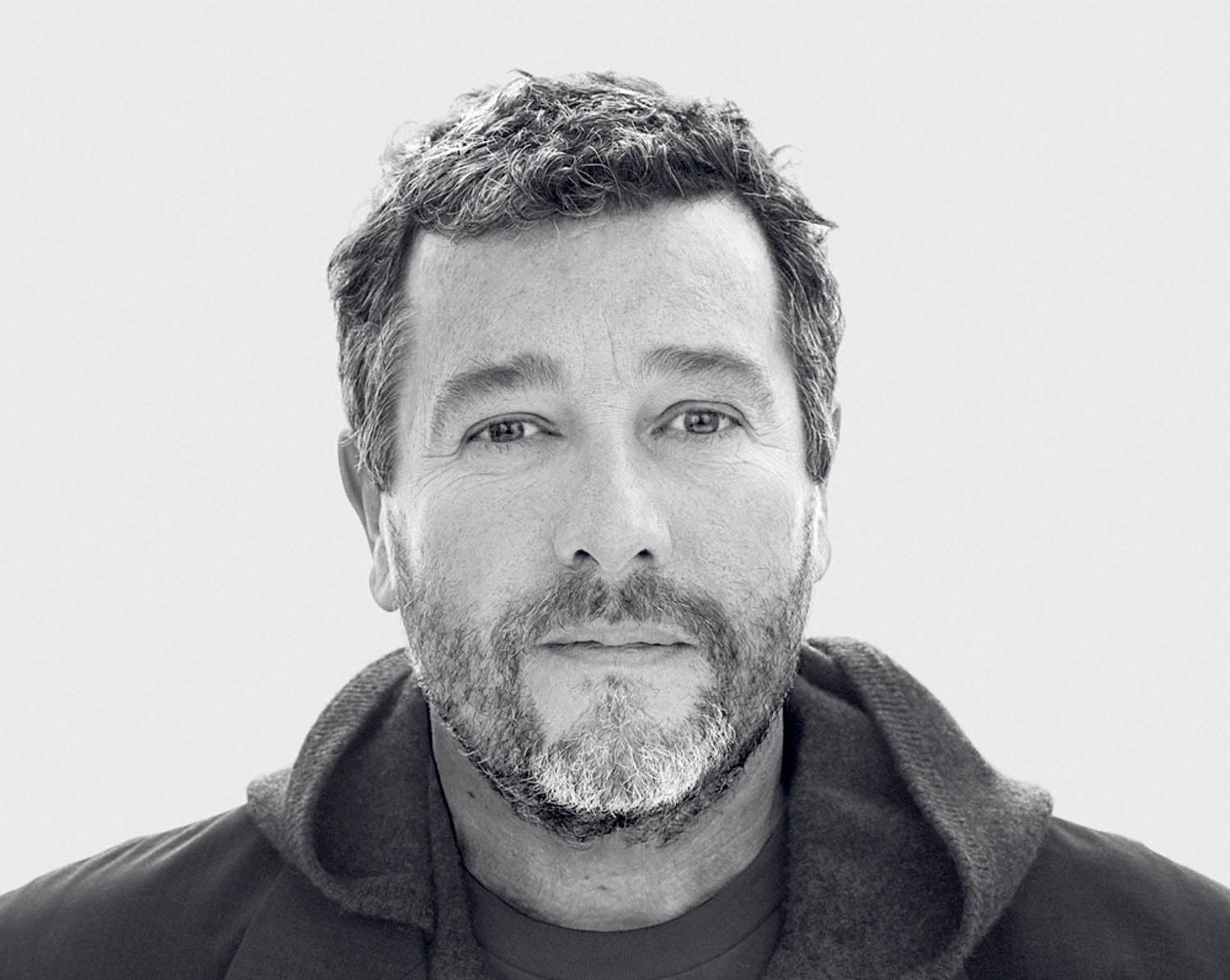 A man with a beard and a black shirt.