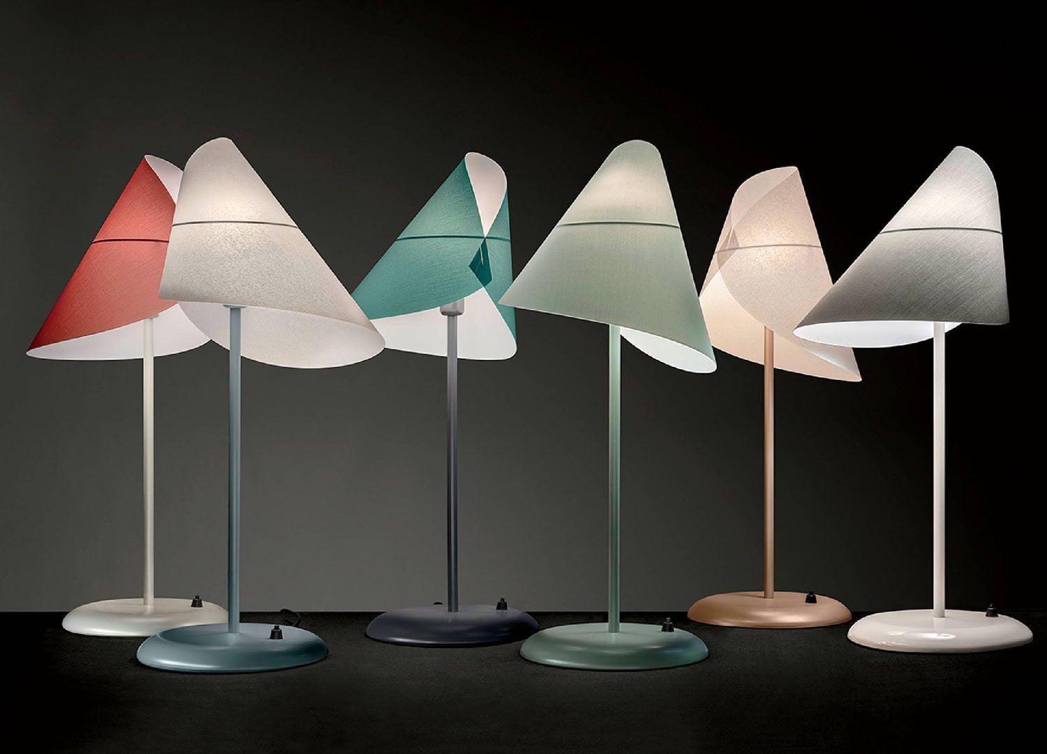 Three lamps with different shades on them.