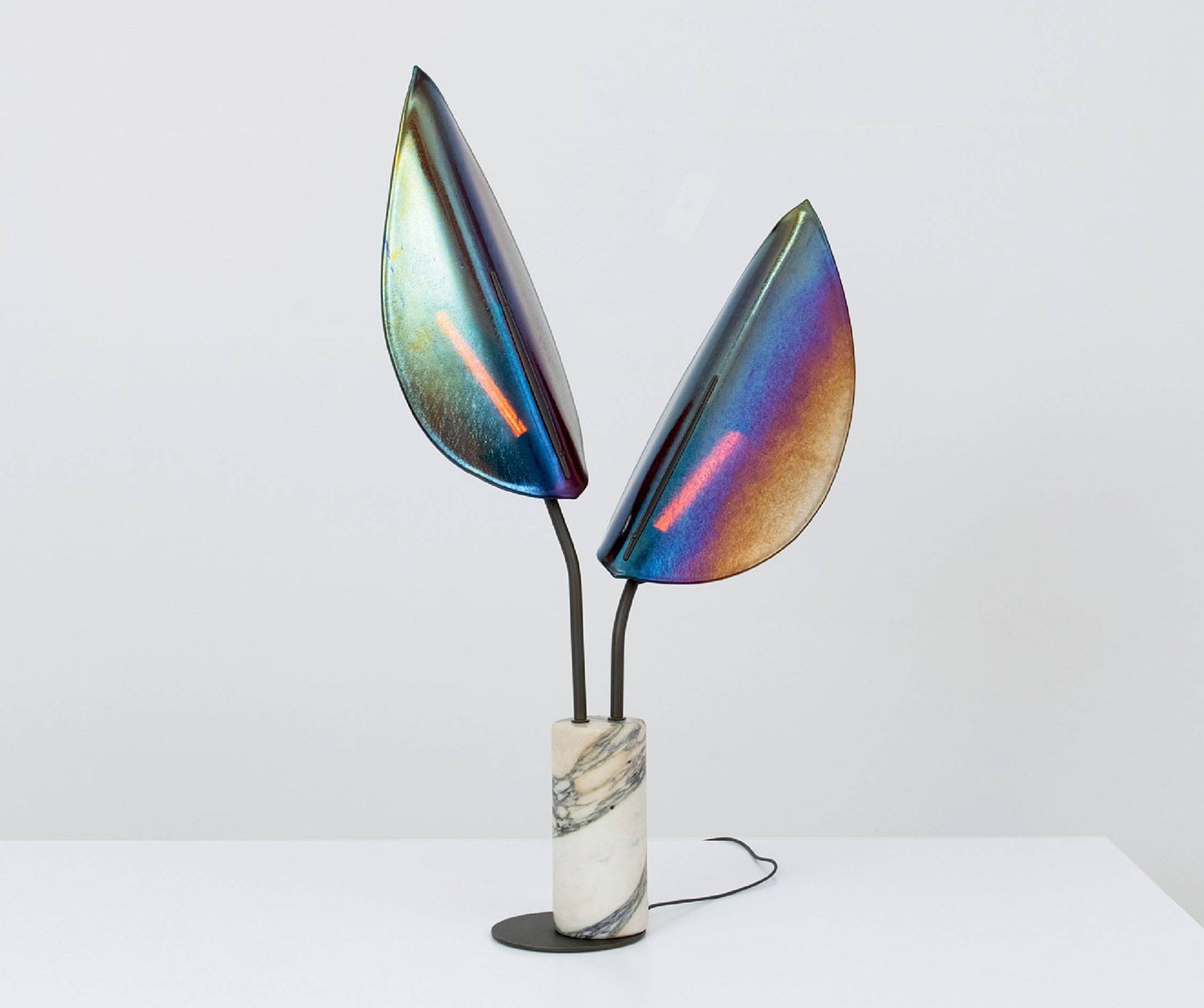 A colorful vase with a flower in it.