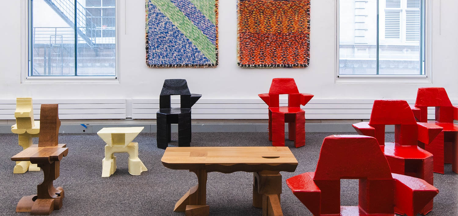 room with colorful chair surrounding a wooden table