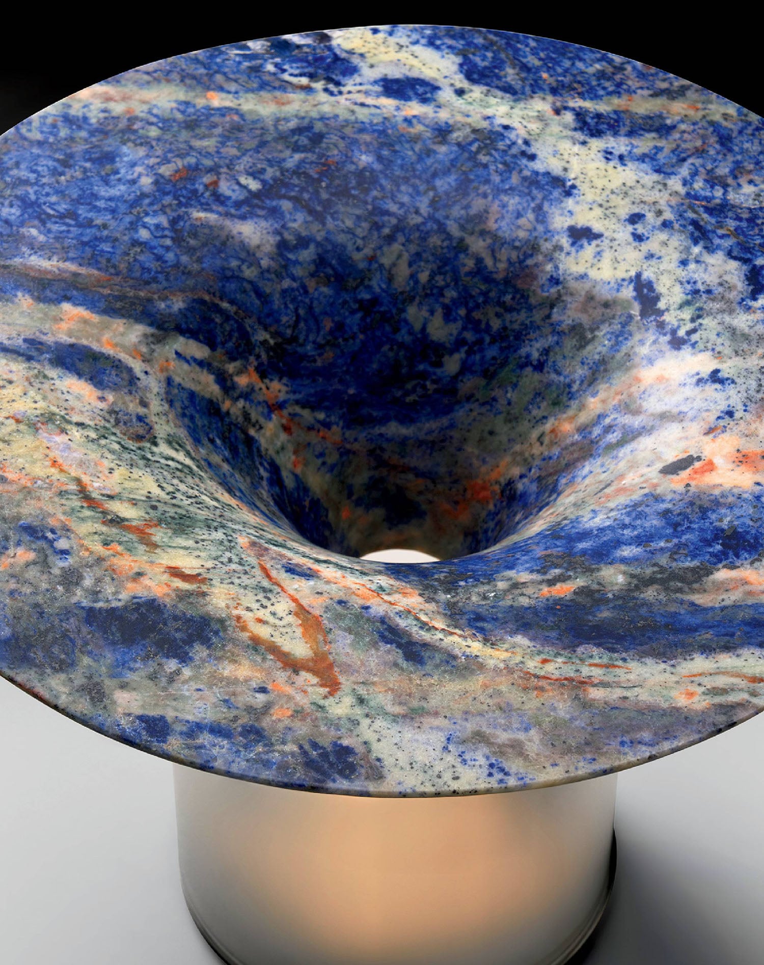 A blue and white bowl with a red and orange swirl.