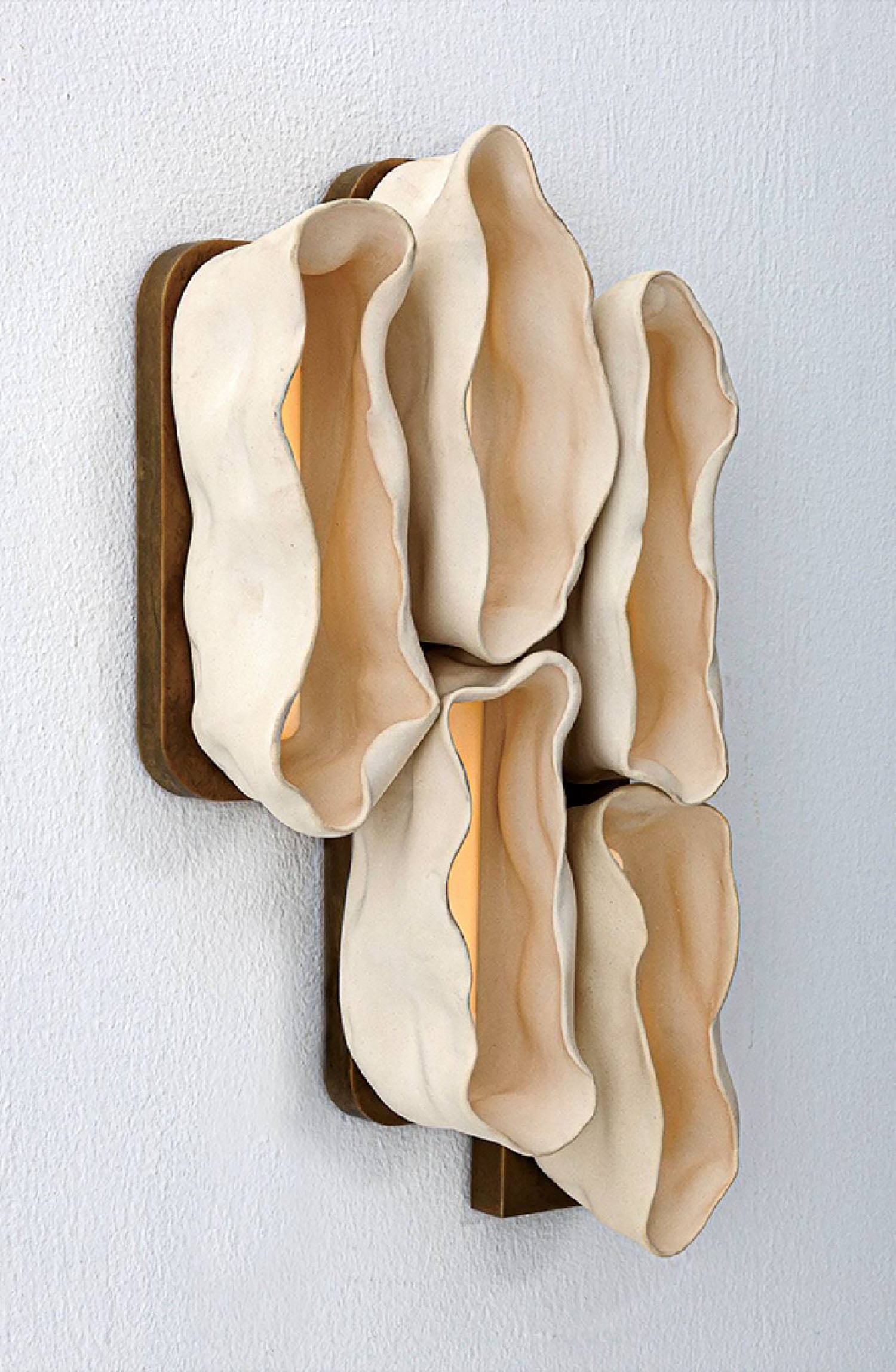 A sculpture made out of clay and wood.