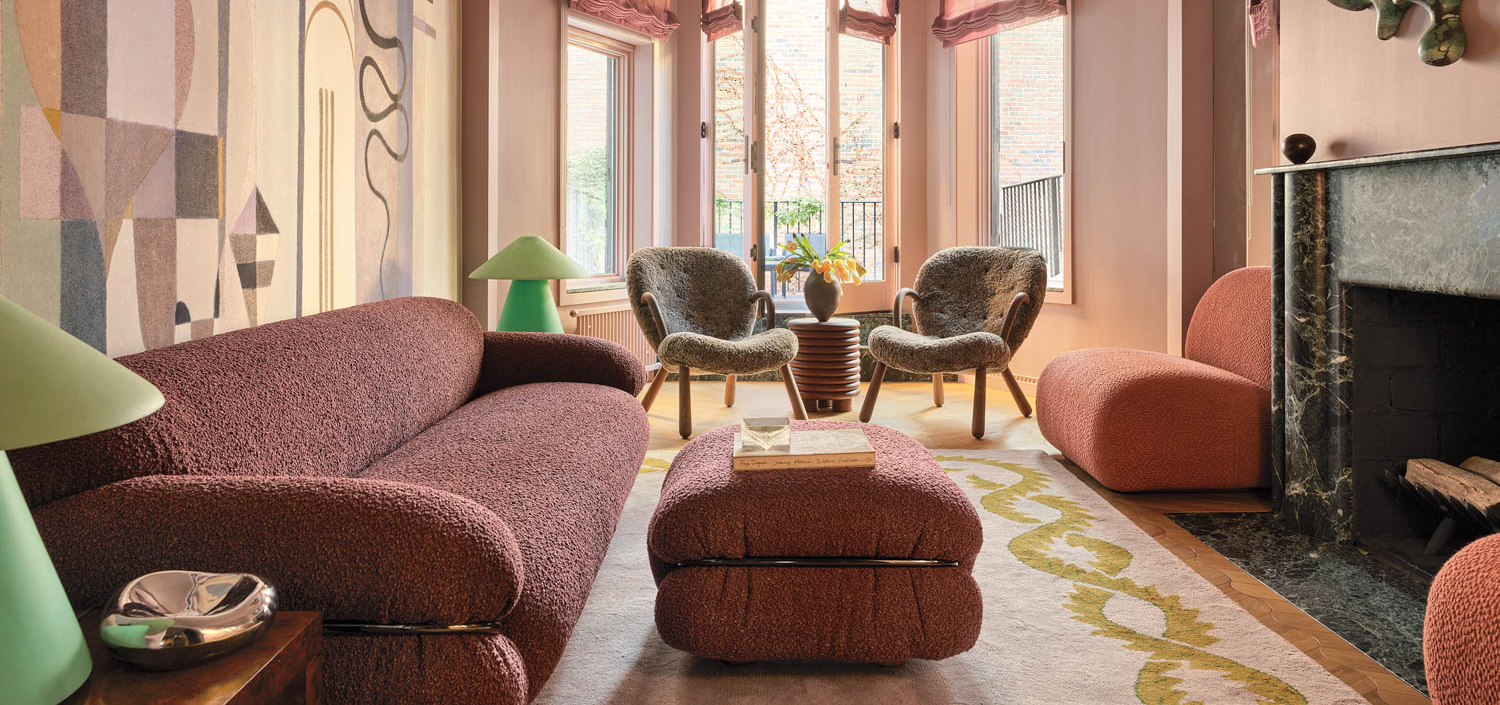 living room with dark pink paint on walls, black fireplace and view to balcony