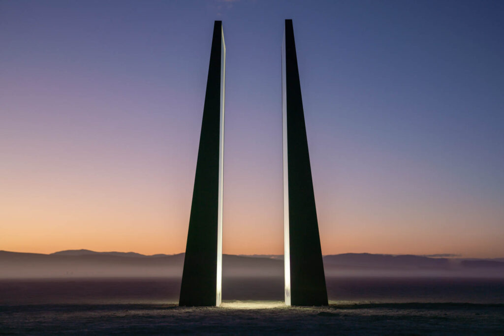 two rocks with light beams