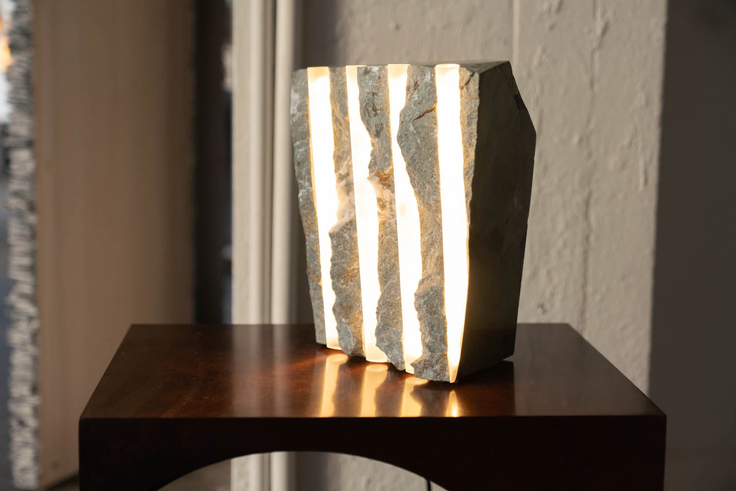 solid rock sculpture with multiple light pieces