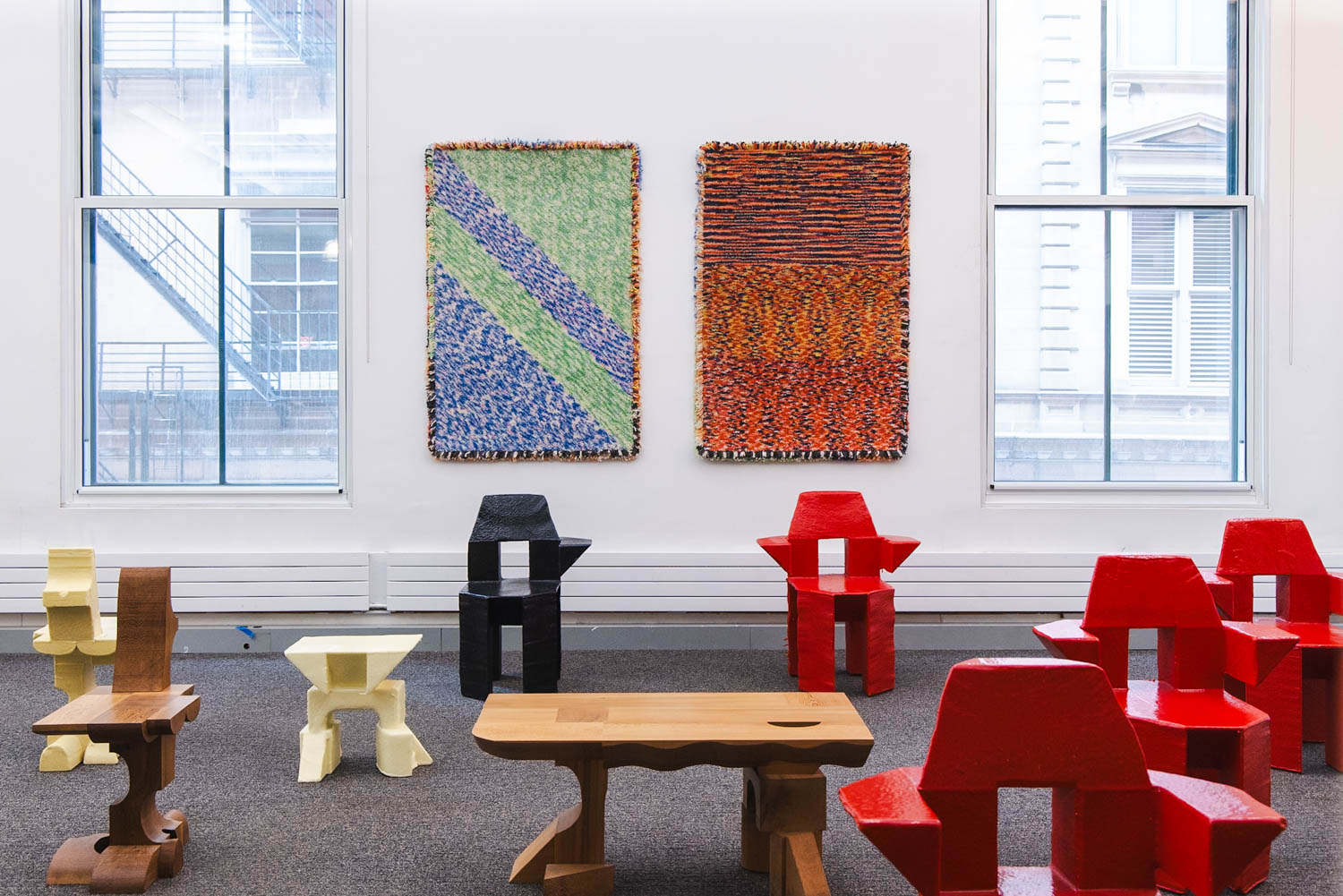 room with colorful chair surrounding a wooden table