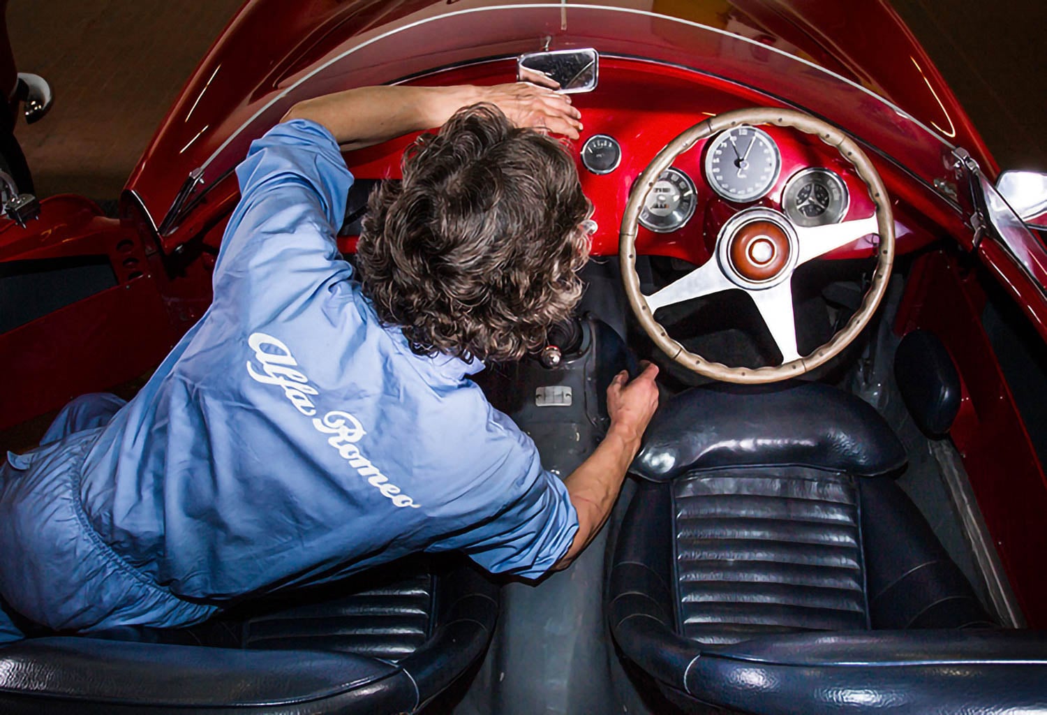 person fixing the steering wheel inside the Maserati