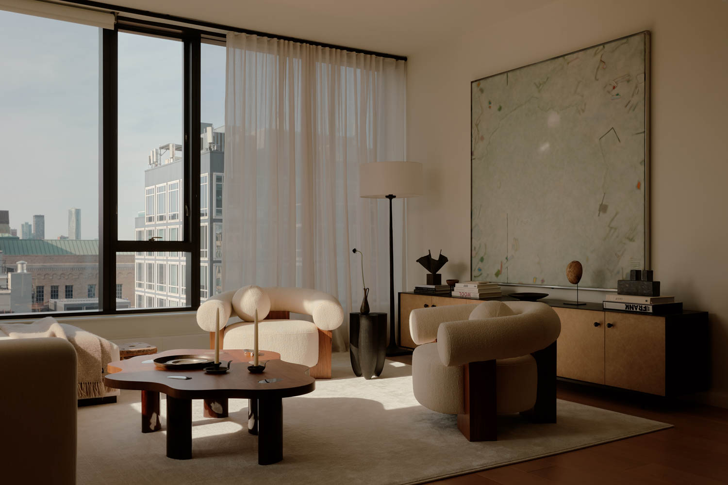living room with custom steel and leather console and white chairs