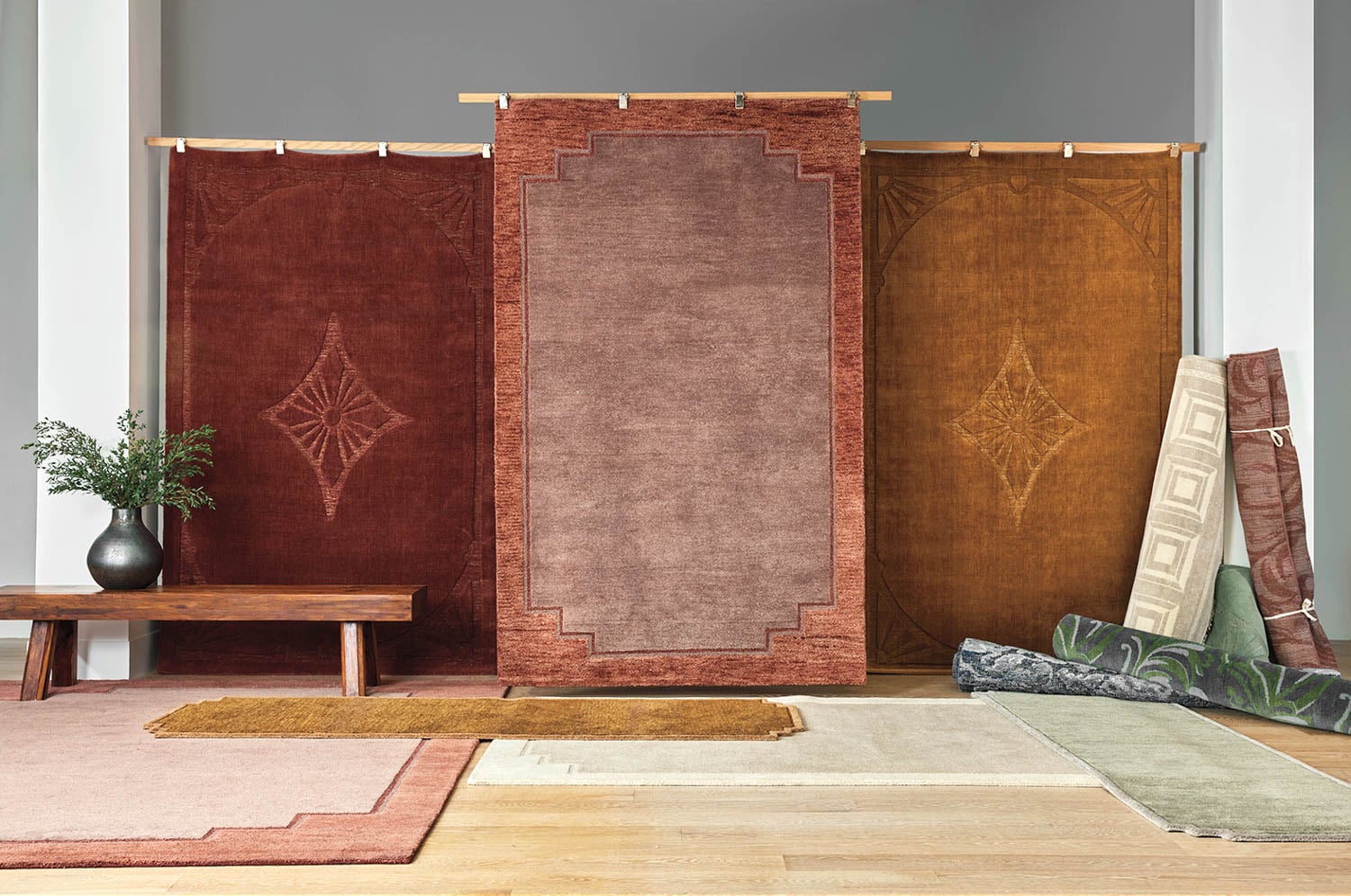 multiple rugs hanging in room