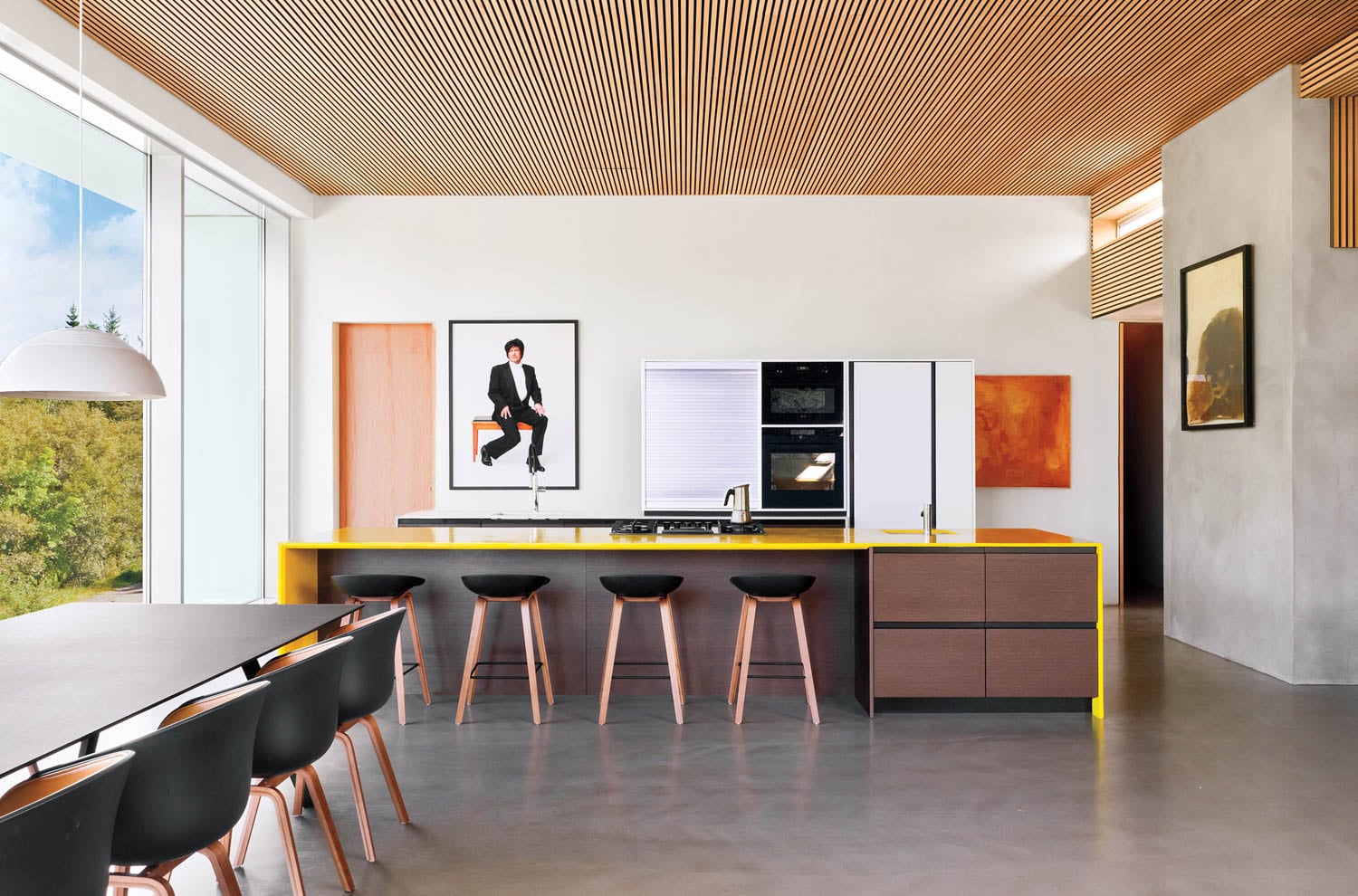 dining area with kitchen island and portrait of person dancing