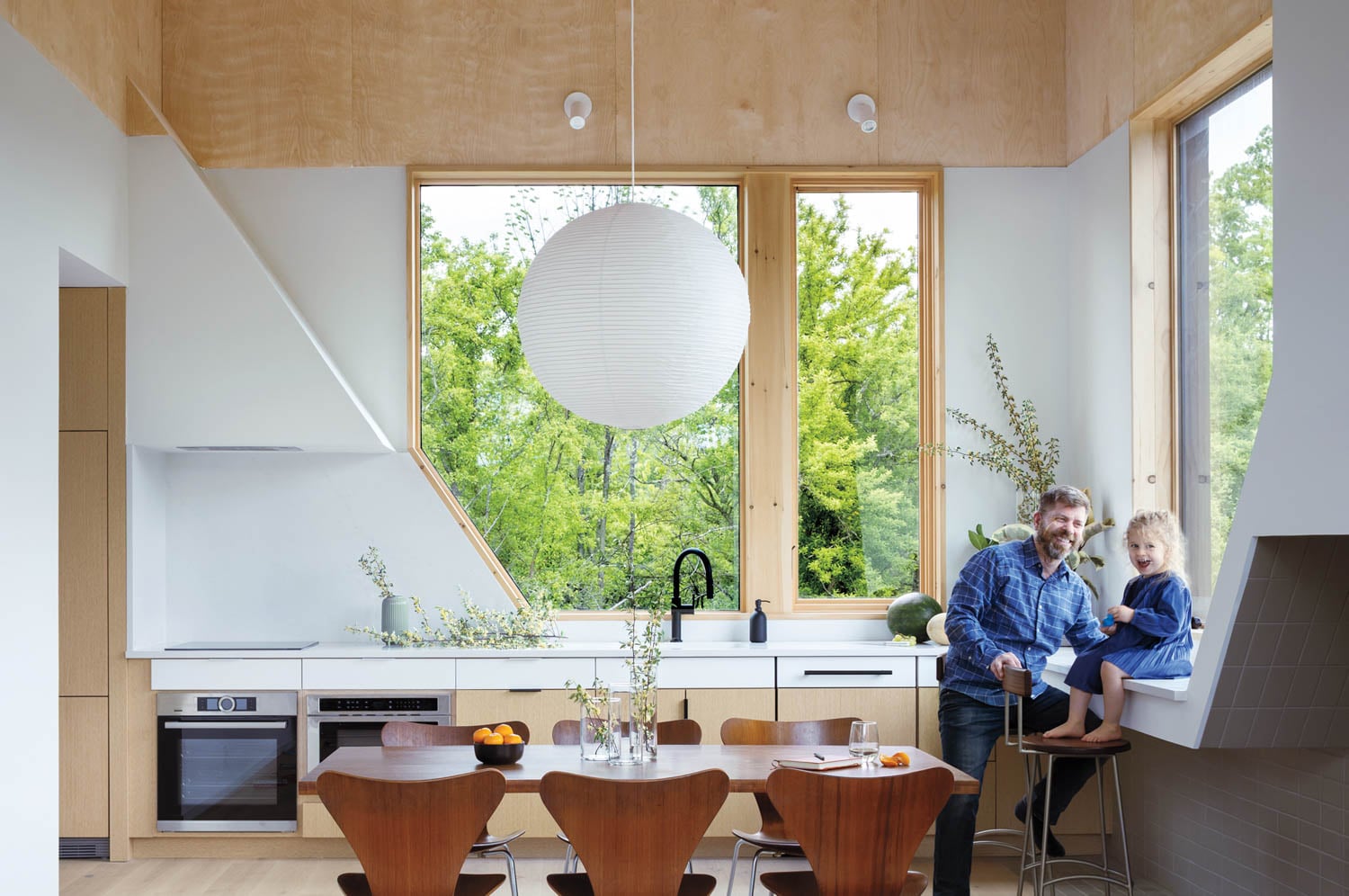 two people sitting in kitchen and dining room area