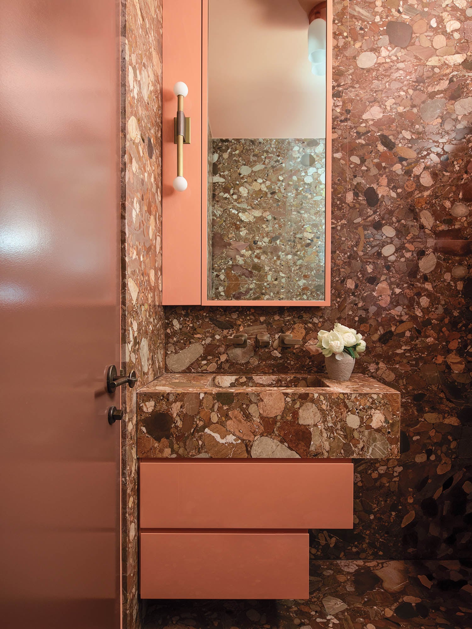 bathroom with pale pink stone and furnishings