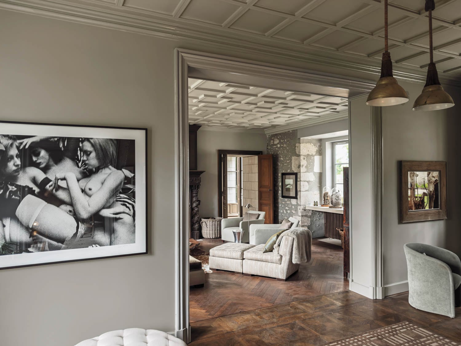 dining room leading to the living room with provocative photograph