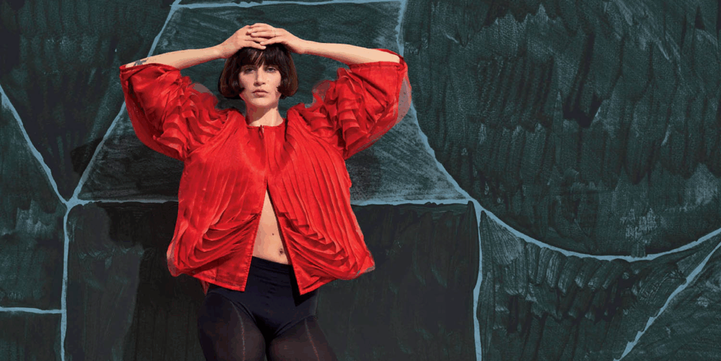 woman in red standing against backdrop
