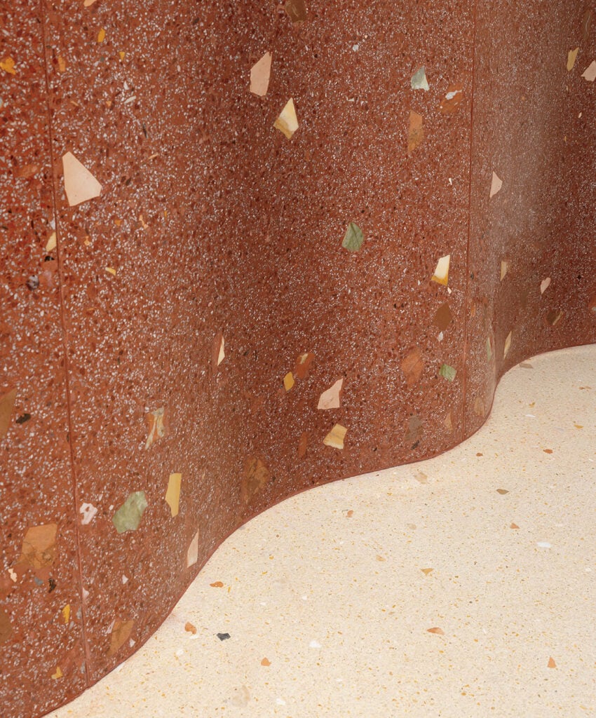 A cat sitting on a ledge in a room.