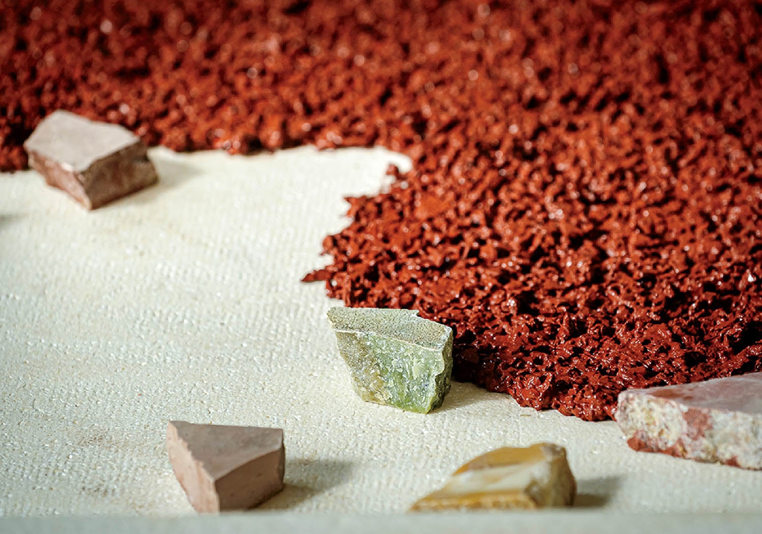 A pile of red colored rocks on a table.