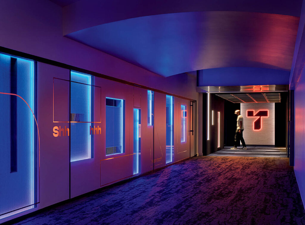 A hallway with a blue light and a red light.