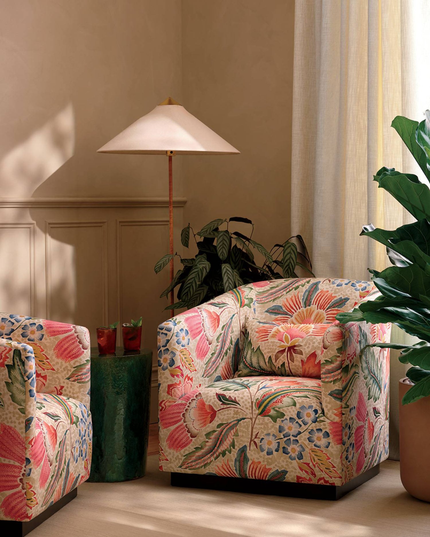 A living room with a plant and a chair.