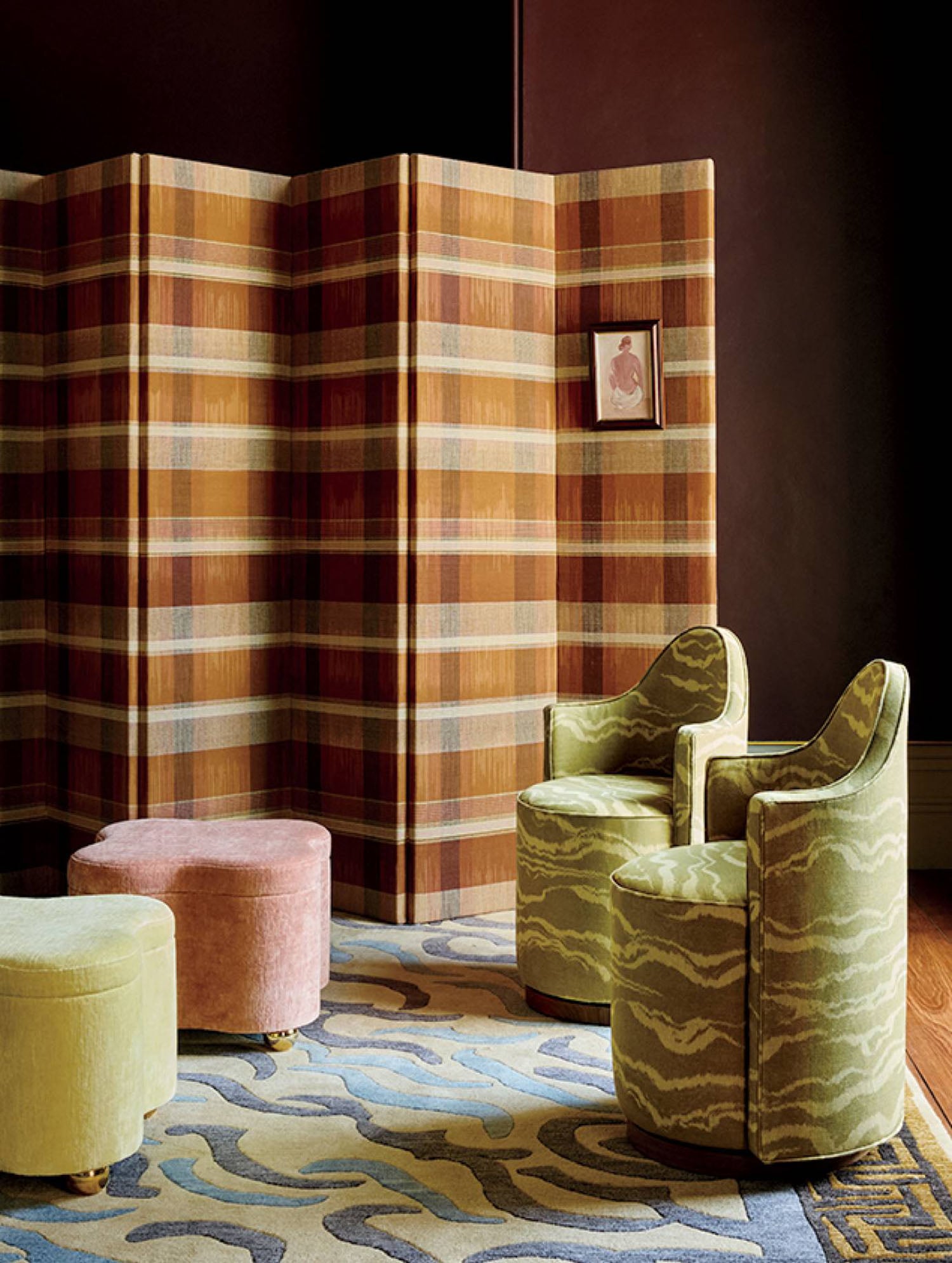 A room with a rug and a chair.