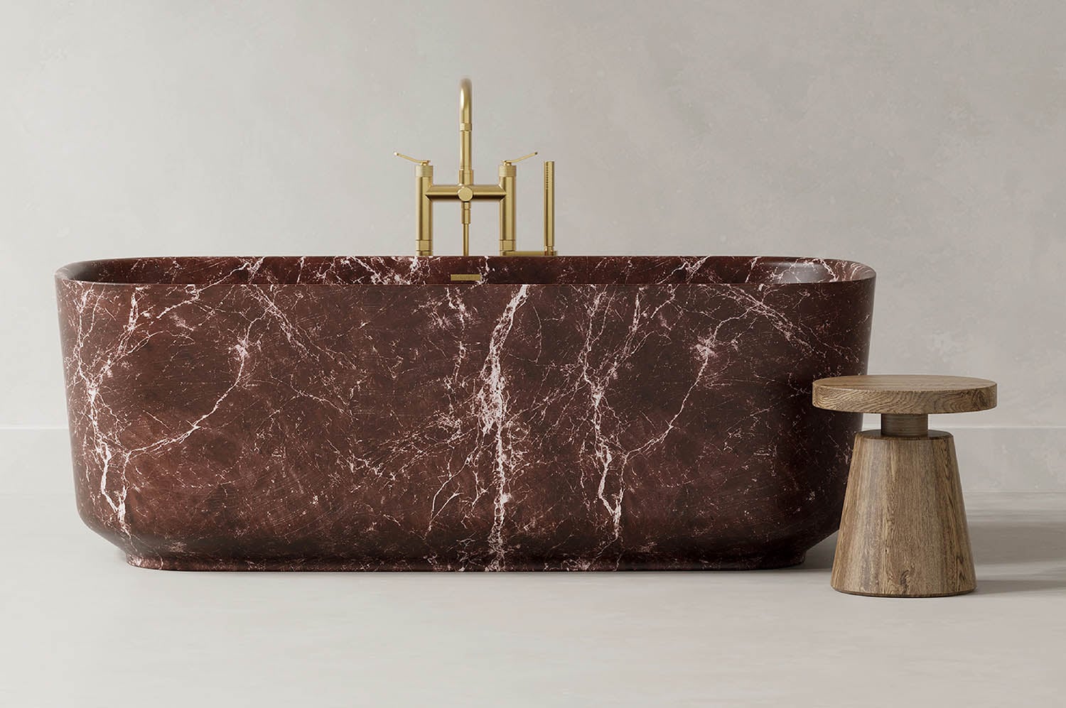 A bathtub with a marble finish and brass fixtures.