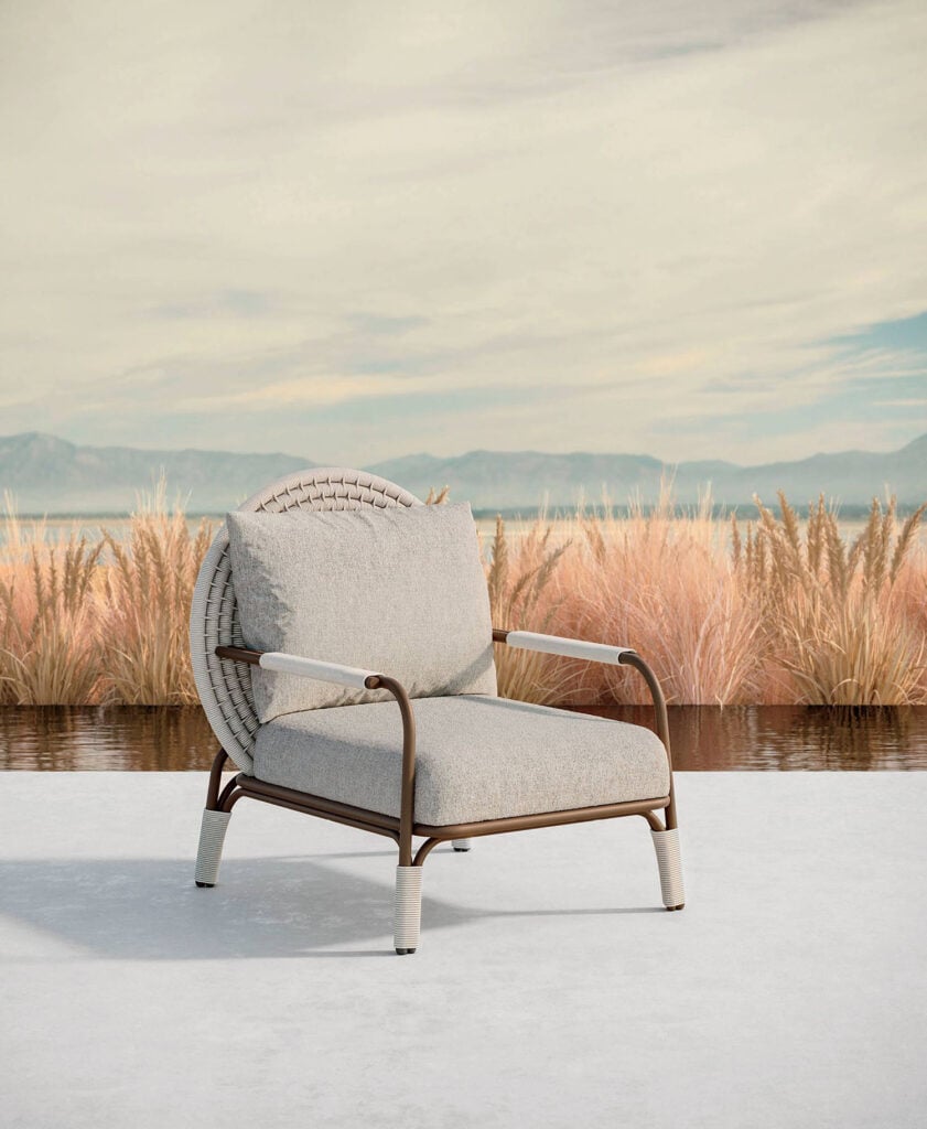 A chair sitting on a white surface with a lake in the background.