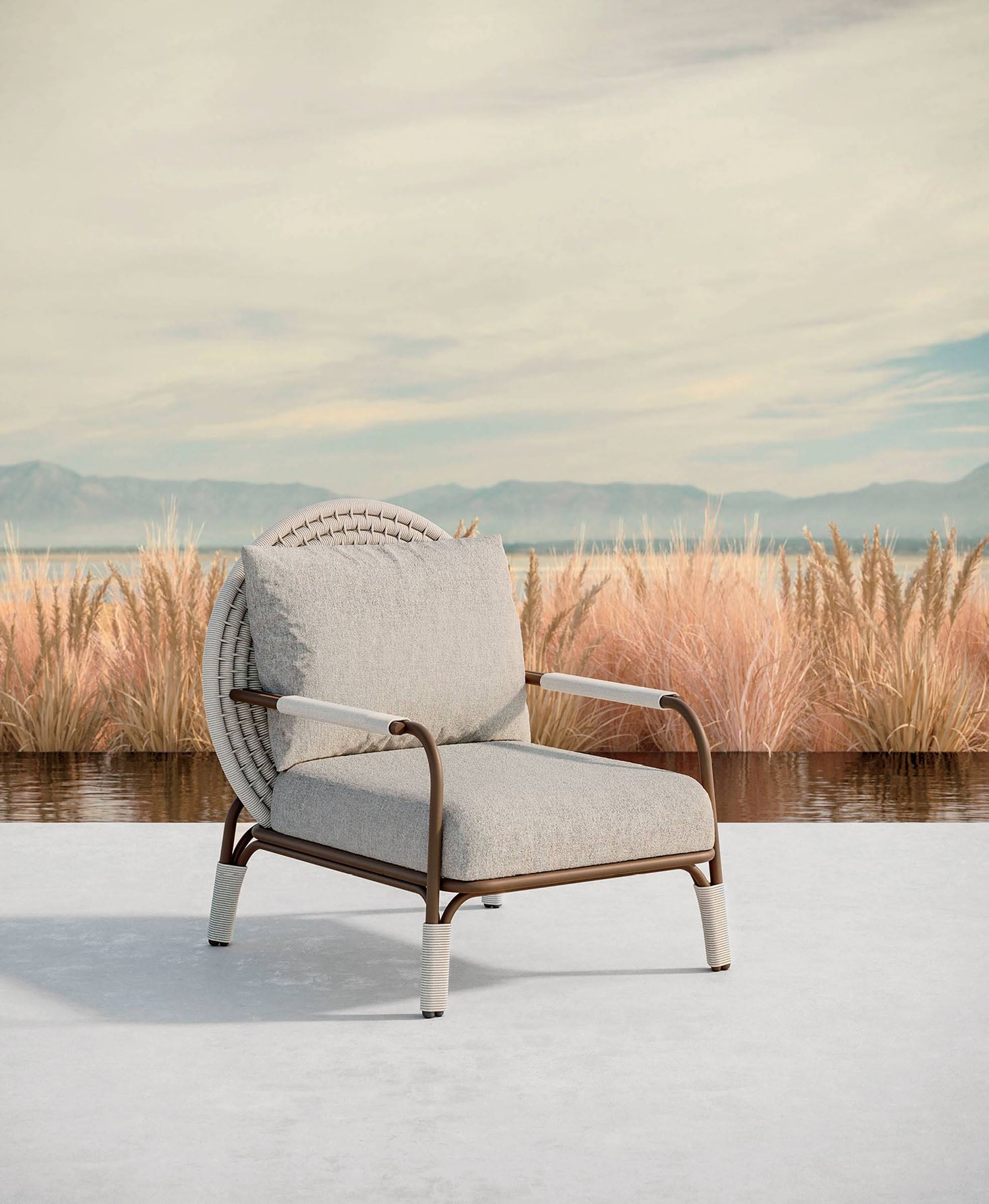 A chair sitting on a white surface with a lake in the background.