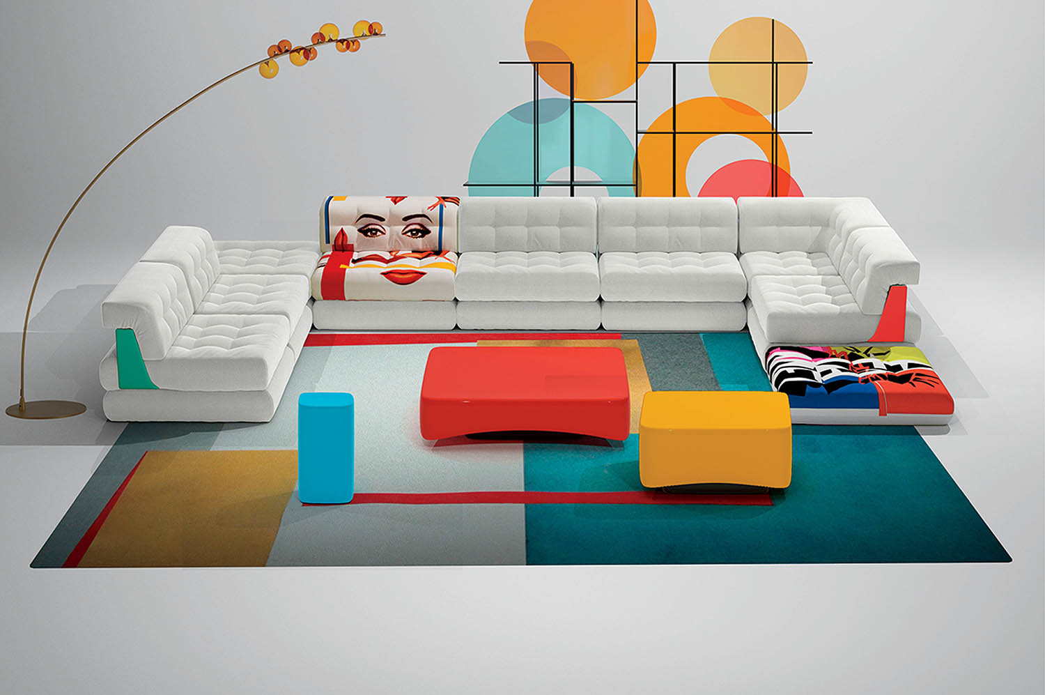 A living room with a large white couch and colorful rugs.