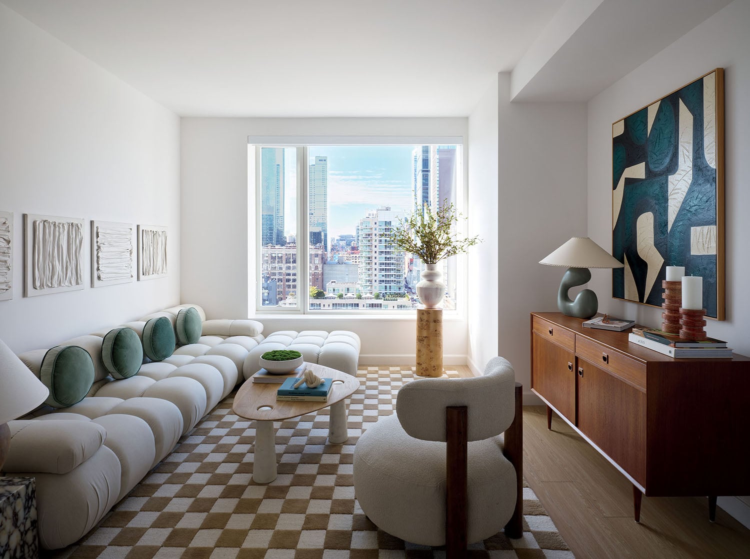 A living room with a checkered floor and a checkered rug.