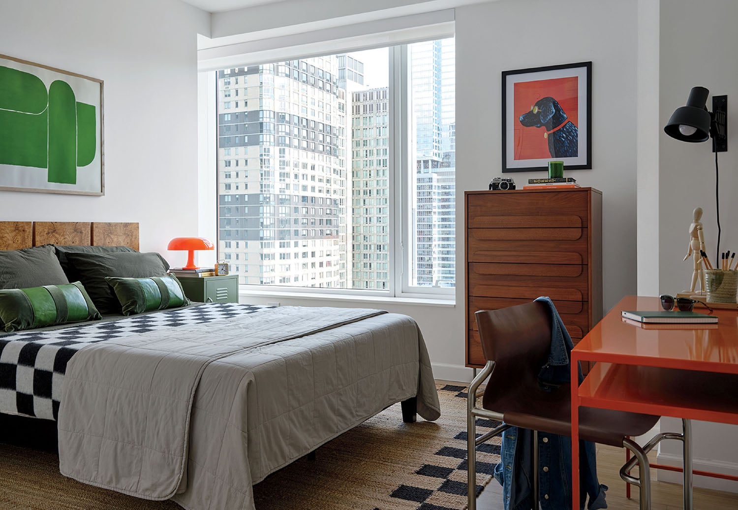 A bedroom with a bed and a desk.