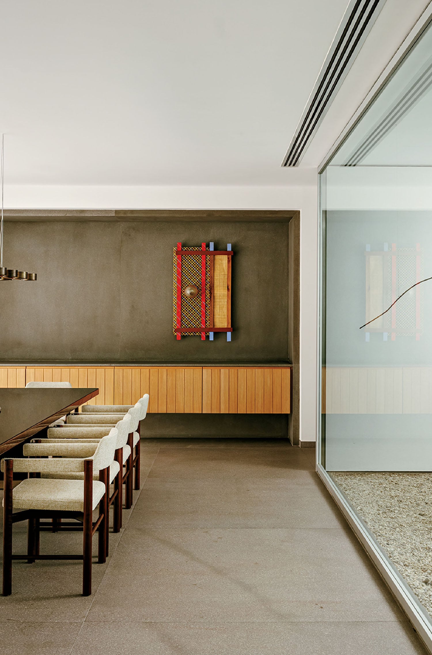 A dining room with a long table and chairs.