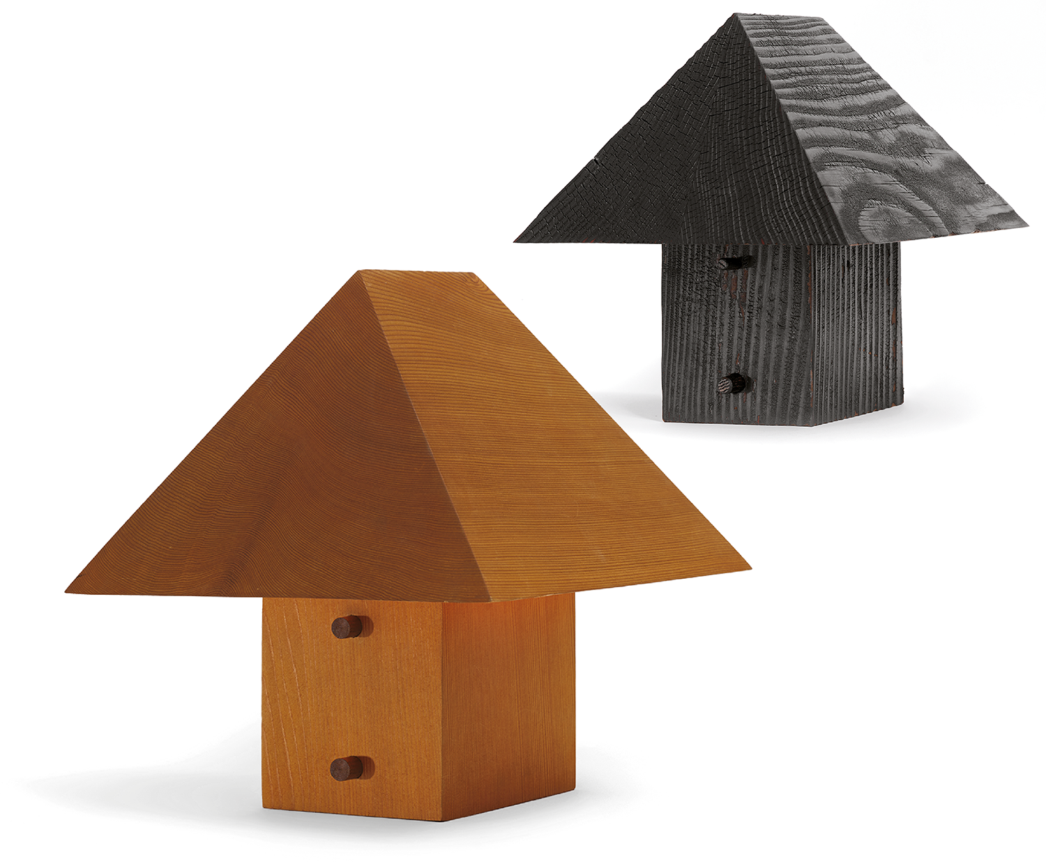 A birdhouse made from wood and painted black & A wooden bird house with a bird inside.