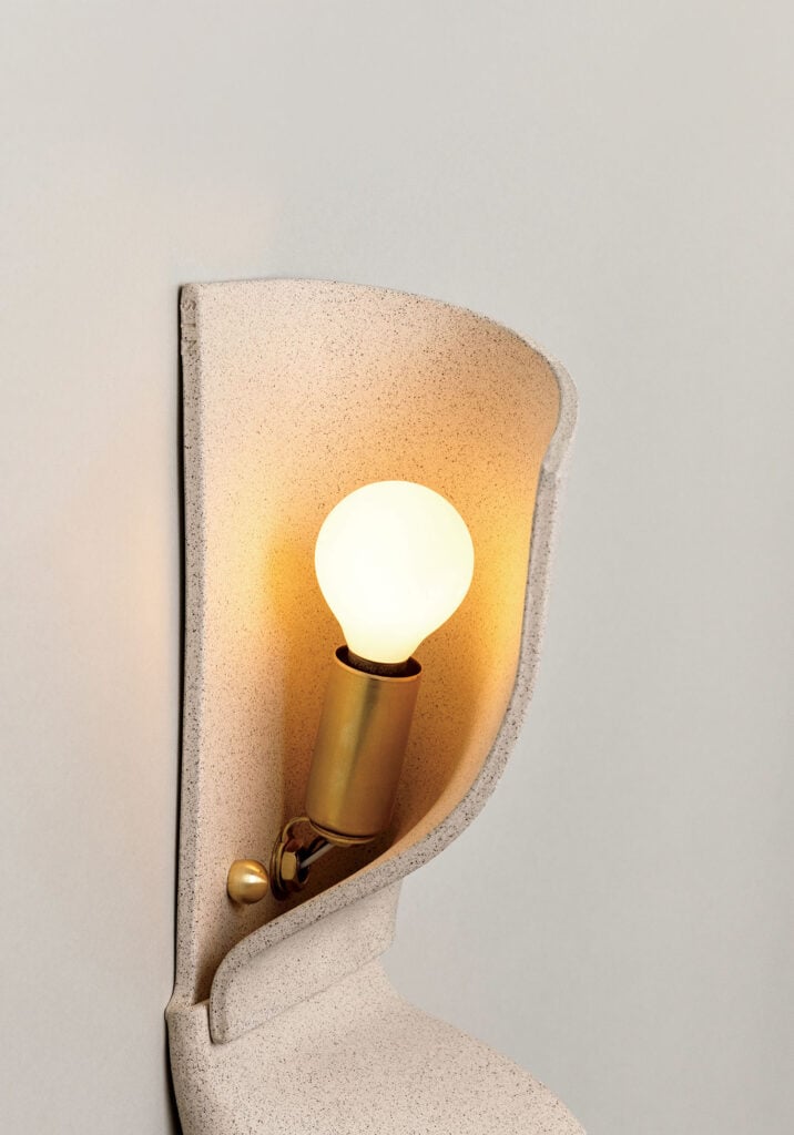 A wall light with a white light on it.
