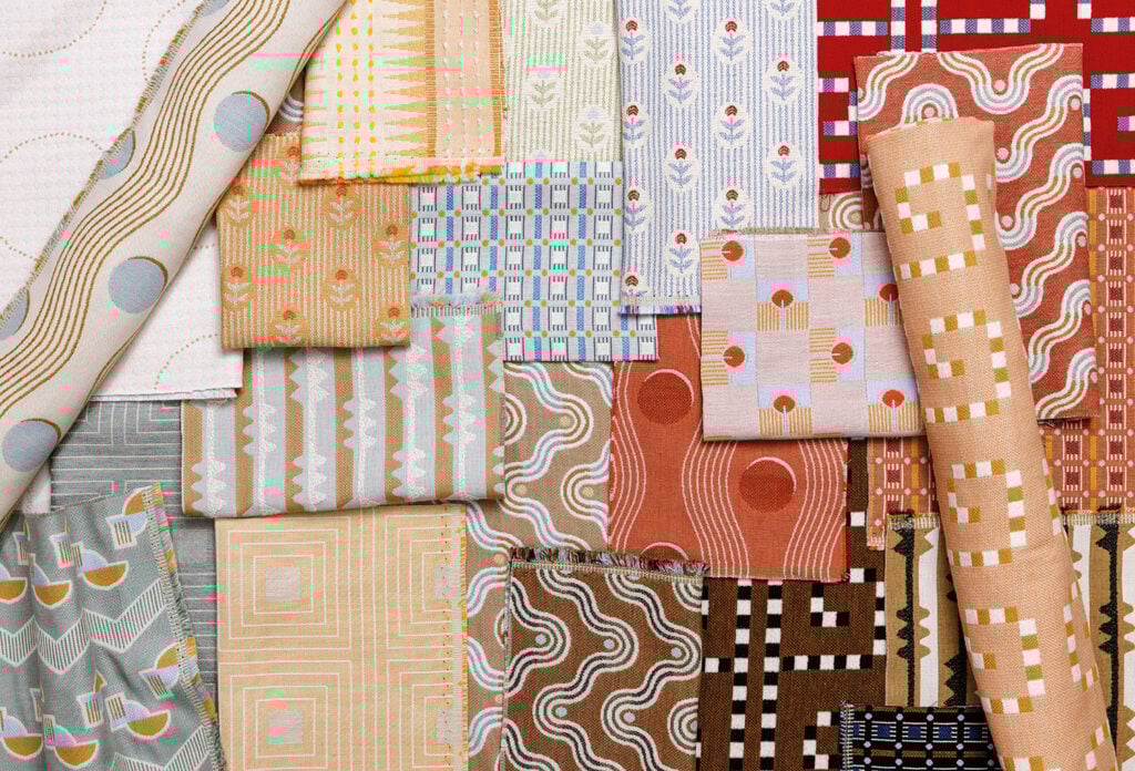 A pile of different colored patterned fabric.