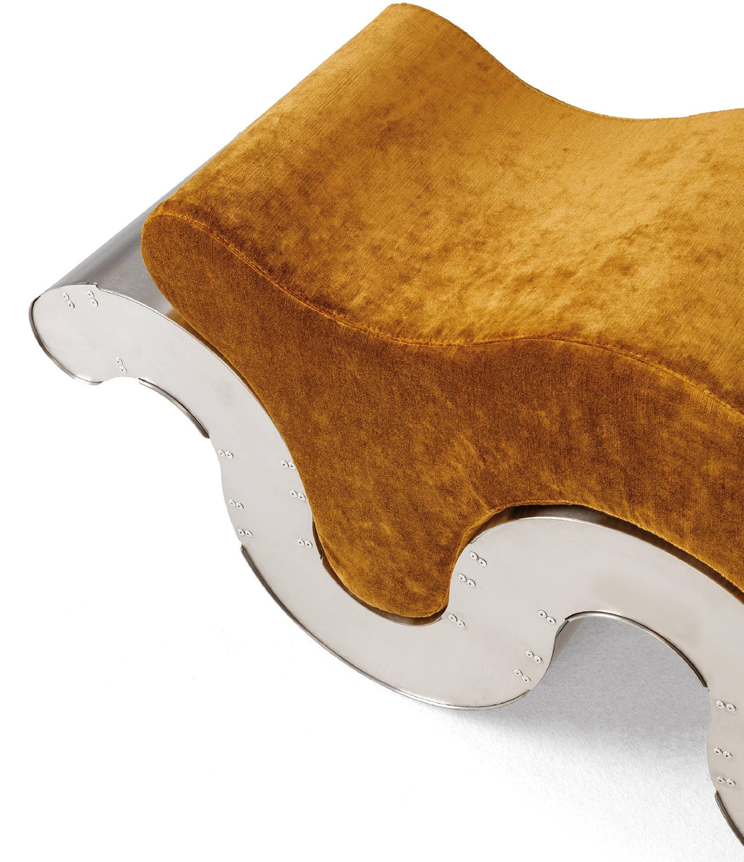 a gold velvet footsto with silver trim