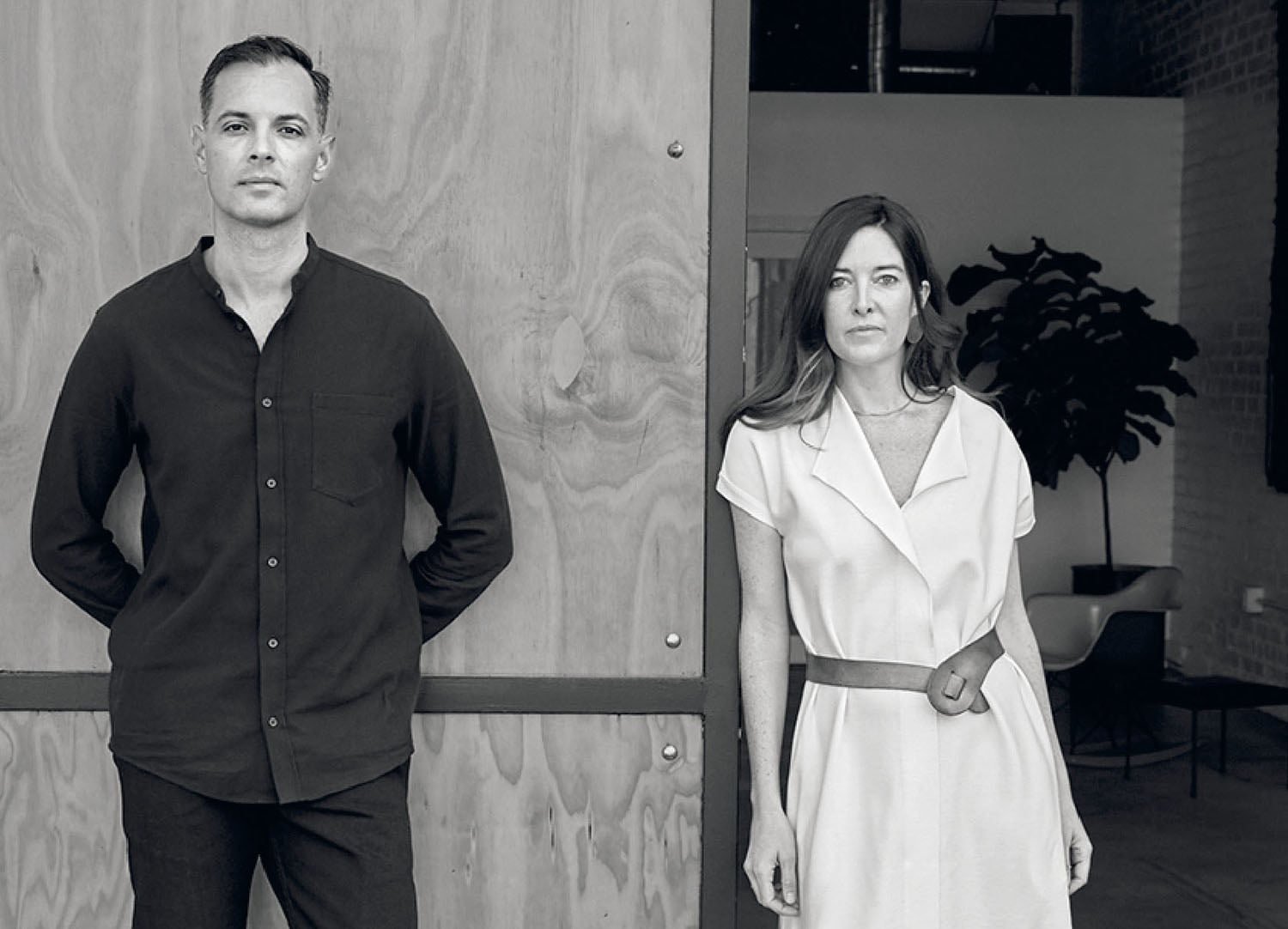 A man and woman standing in front of a door.
