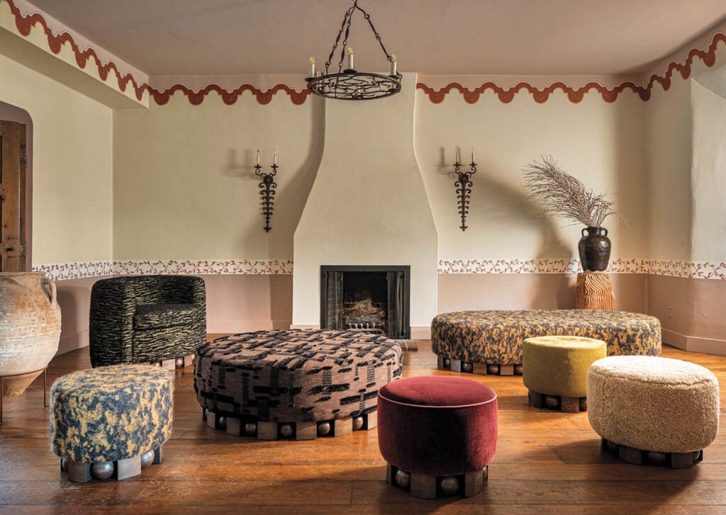 a living room with colorful ottomans