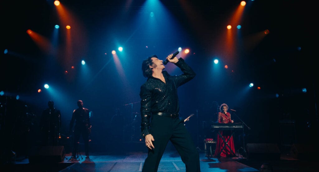 man singing on stage