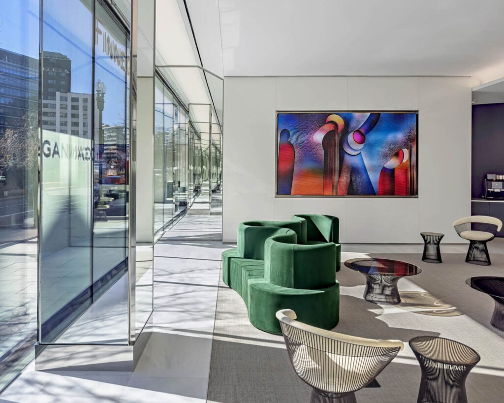 lobby area with dark green chairs and artwork