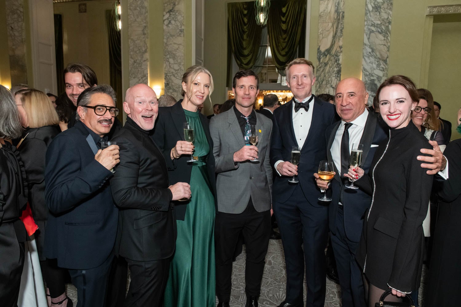 attendees posing at Waldorf Astoria ballroom during cocktail hour