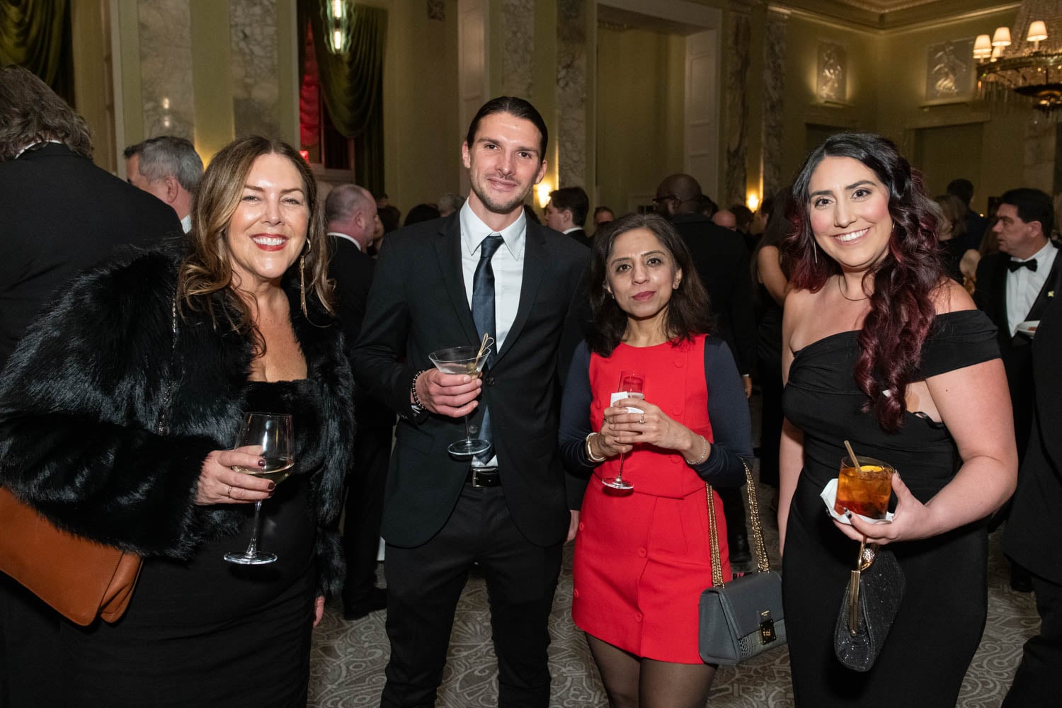 attendees posing at ballroom during cocktail hour