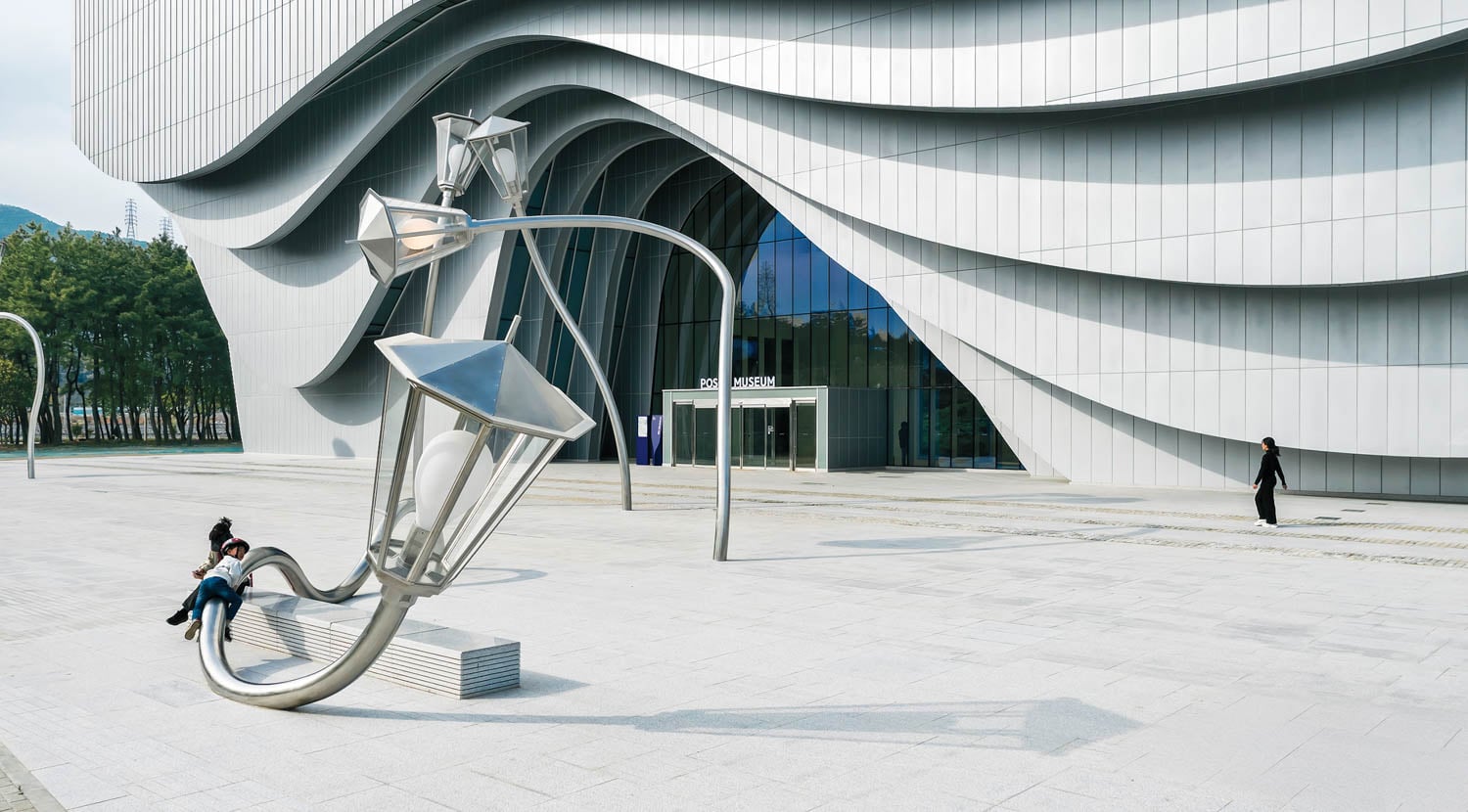 a metal sculpture of an abstract person