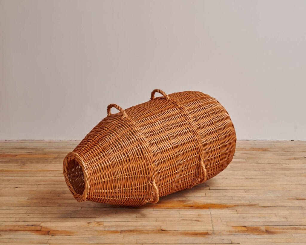 a basket with handles o the sides for carrying fish