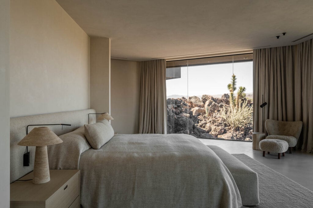 main bedroom with gray comforter and desert views