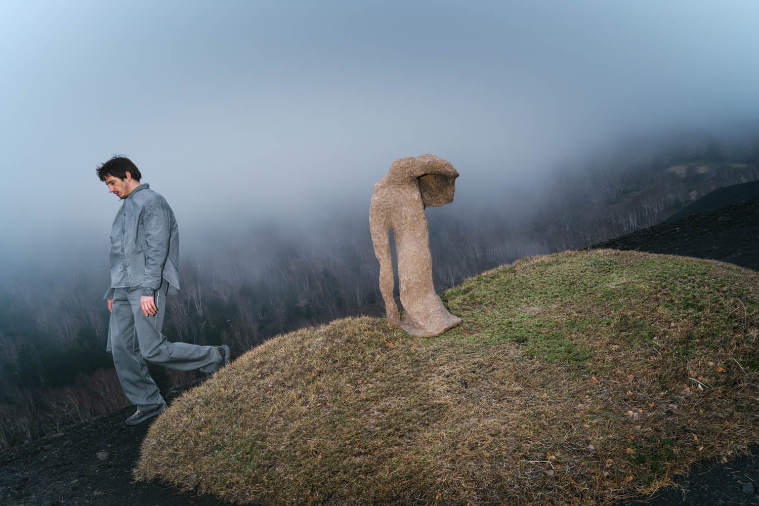 artist next to sculpture