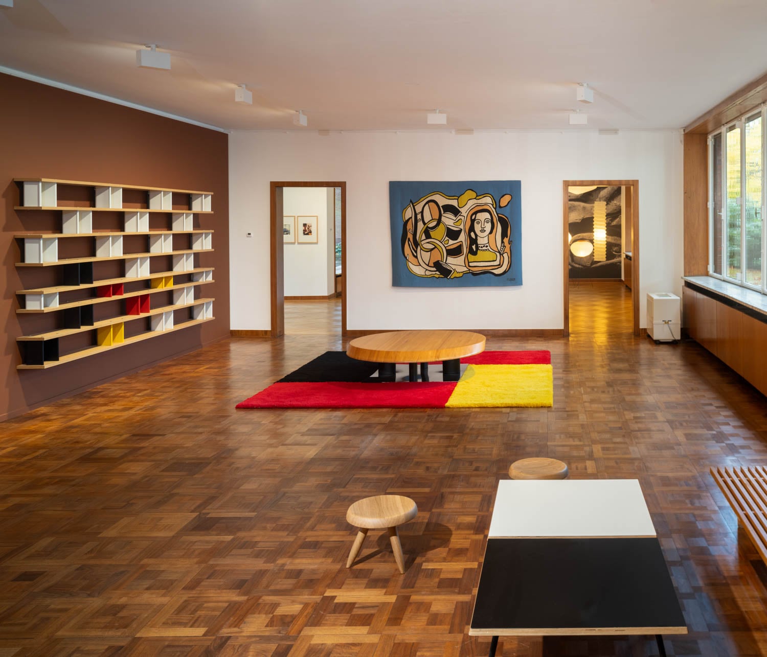 room with wooden floors and bright rug