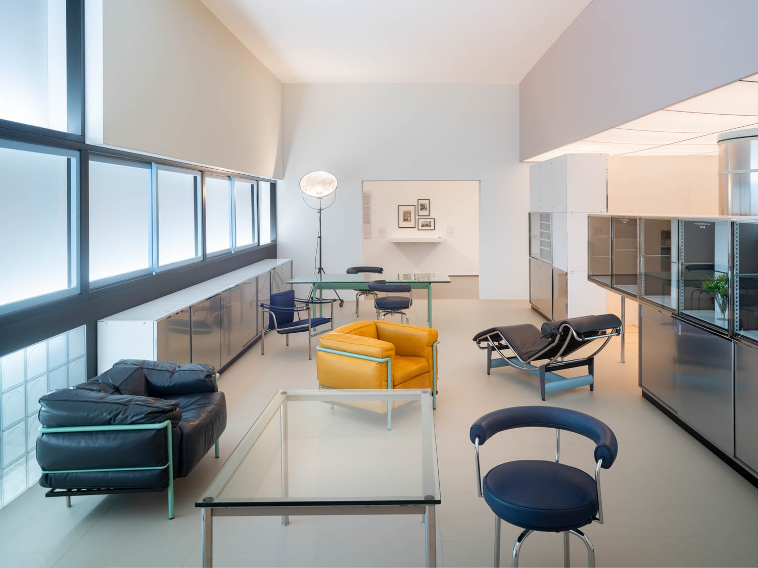 room with blue chairs and yellow chair in center